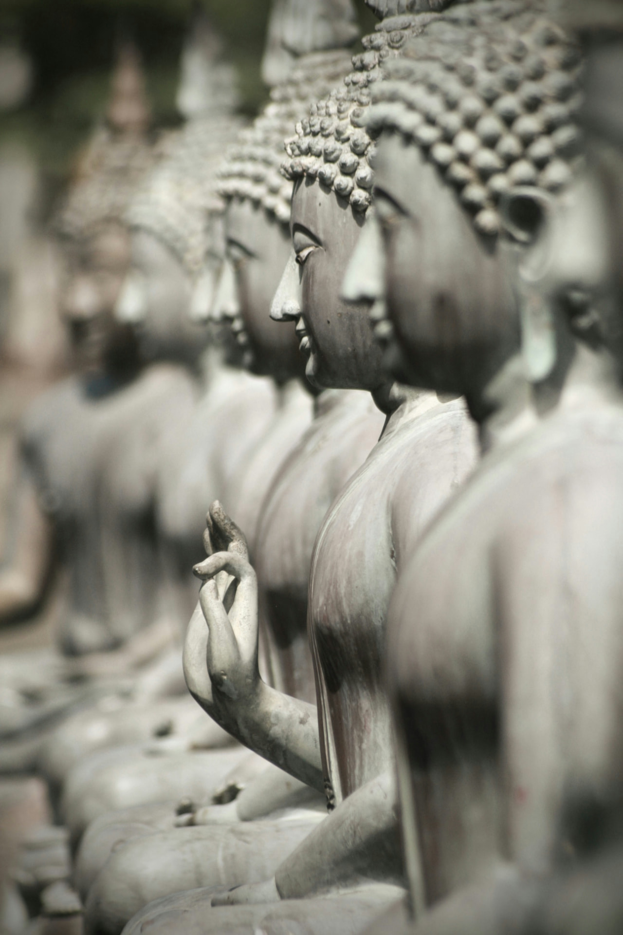 Row of seated stone Buddha statues at a Sri Lankan temple